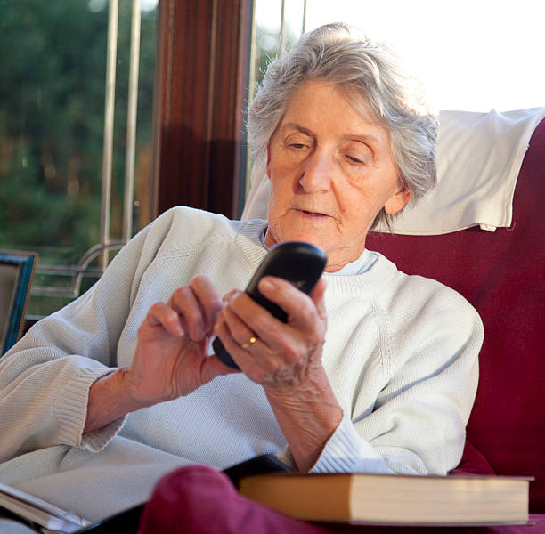istock senior woman making phone call 526059809