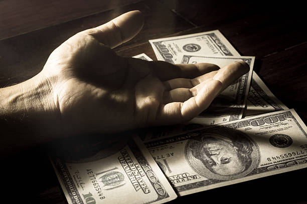 istock Black and white filtered human hand on money. 526059965