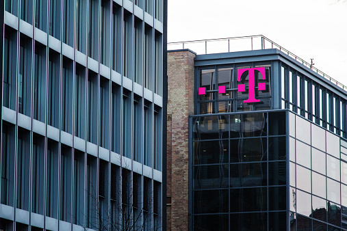 Berlin, Germany - November 27, 2014: T Mobile Sign at building in Berlin. The mobile company is primarily known with its C- network coverage available in Germany , which was shut down on 31 December 2000.