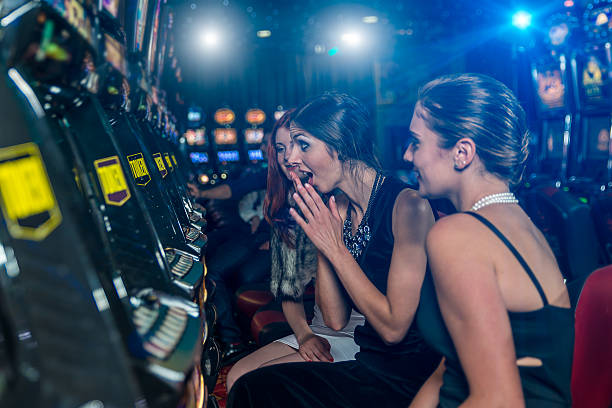 Woman in a casino winning at slot machine stock photo