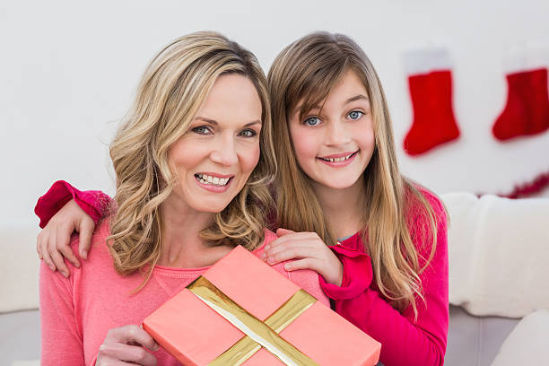 istock Festive mother and daughter smiling at camera 526060435