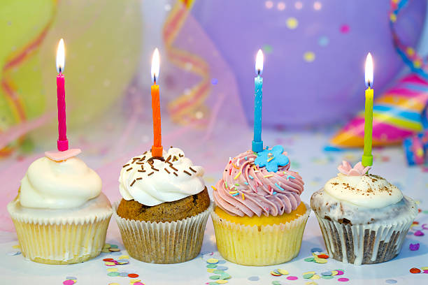 istock Birthday cupcake closeup on colorful background with candle 526069305