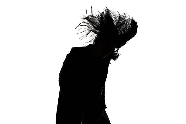 istock Image of man's silhouette with blowing hair 526069617