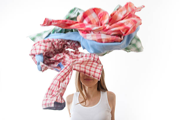 istock woman throws a pile of clothes, isolated on white 526070567