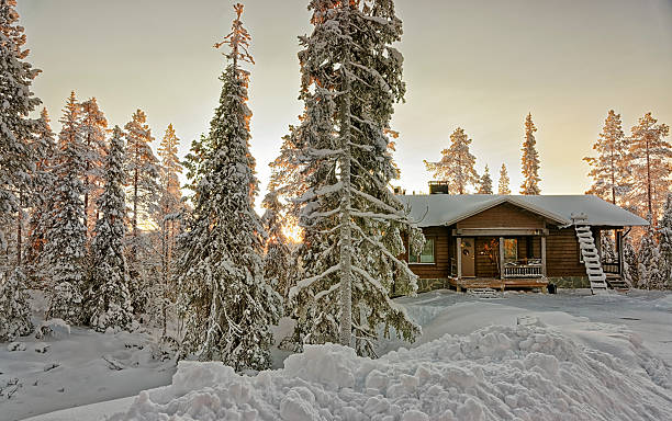 istock Cottage in snowy winter forest at sunset 526072025