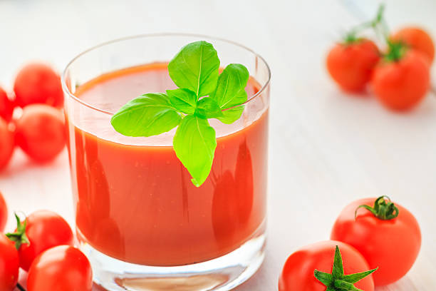 istock Fresh tomato juice wooden background 526073341