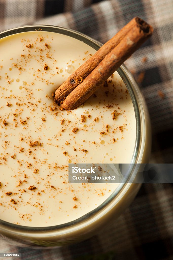 Homemade White Holiday Eggnog Homemade White Holiday Eggnog with a Cinnamon Stick Alcohol - Drink Stock Photo