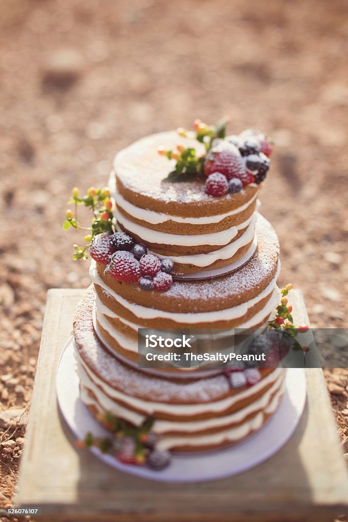 Naked wedding cake Naked wedding cake decorated with different blueberries, blackberries and raspberries. Blackberry - Fruit Stock Photo