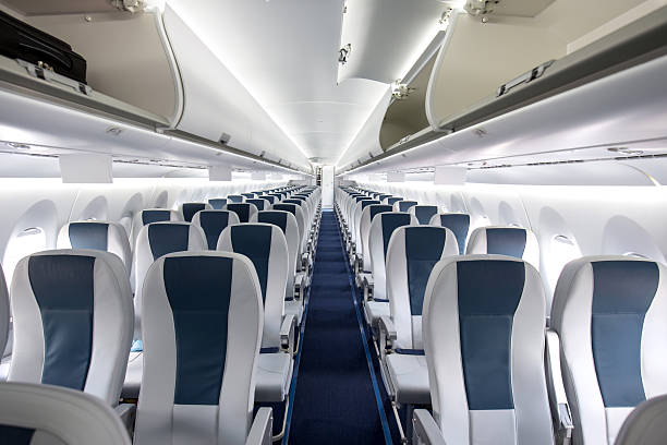 Commercial Passenger Aircraft Cabin Interior of a large empty commercial passenger aircraft. window seat vehicle stock pictures, royalty-free photos & images