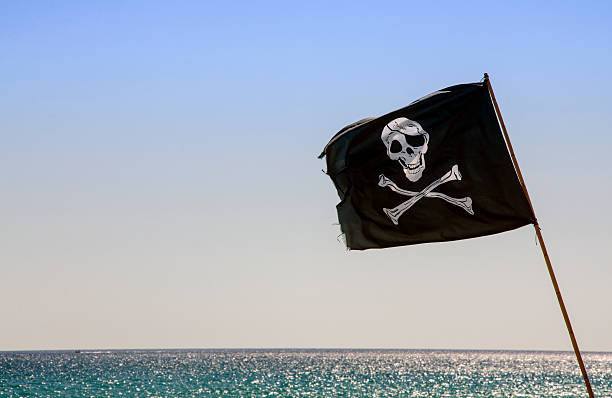 pirate flag waving with blue sea background pirate flag waving with blue sea background horn of africa photos stock pictures, royalty-free photos & images