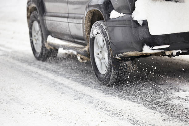 istock Car wheels moving driving in winter road 526091403