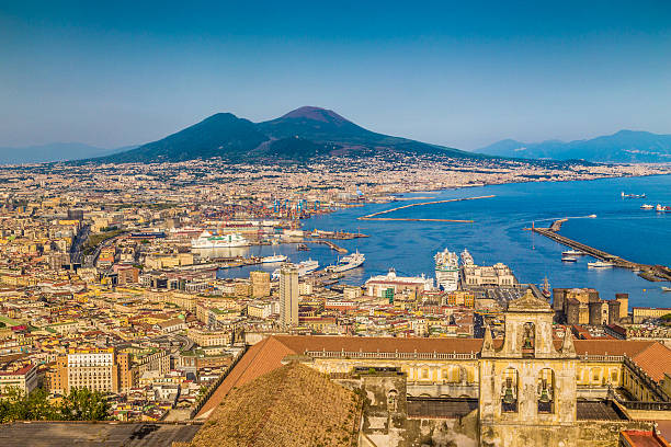 City of Naples with Mt. Vesuvius at sunset, Campania, Italy Scenic picture-postcard view of the city of Napoli (Naples) with famous Mount Vesuvius in the background in golden evening light at sunset, Campania, Italy. active volcano photos stock pictures, royalty-free photos & images