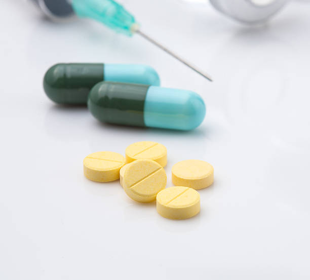 istock tablets with capsule medical ampoule and Syringe on white backgr 526093377