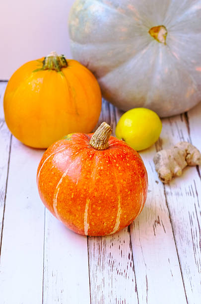 istock pumpkins on a white wooden background 526112415