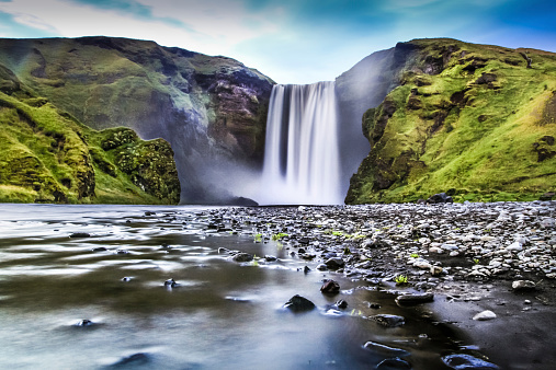 Long exposure of famous Skogafoss waterfall in Iceland at dusk.