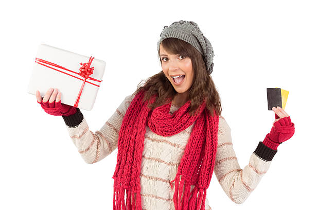 istock Brunette in winter clothes holding gift 526115881