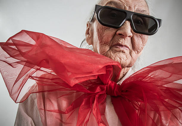 Glamor blonde woman with red lips wearing sunglasses posing near the shutters. Space for text