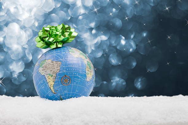 istock Globe in the snow with starry background 526116545