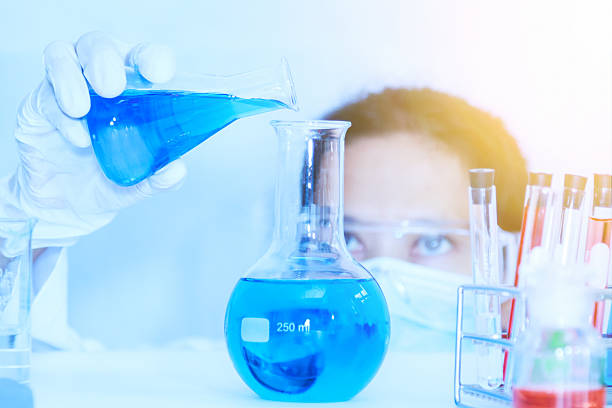 istock Flask in scientist hand with test tubes for analysis. 526124358
