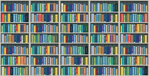 Colorful books on the shelves stacked with shadows.