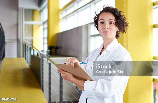 Portrait Of A Female Doctor Holding Her Patient Chart In Stock Photo - Download Image Now