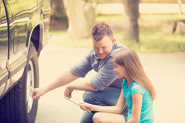 istock Daughter learning from father. Dad, child with tools, repairing vehicle. 526124882