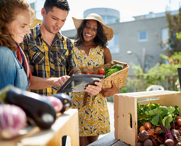 istock Friendly woman tending an organic vegetable stall at a farmer 526124902