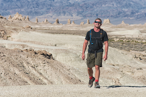 An athletic 32 year old Caucasian male hiking in the Mojave Desert of Southern California.  This shoot was at the Trona Pinnacles National Landmark near Ridgecrest, California.  