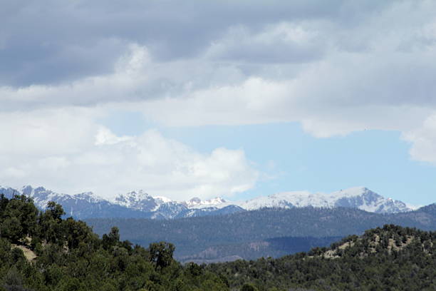 istock Stormy sky, snow topped mountains, evergreen covered hills 526126450