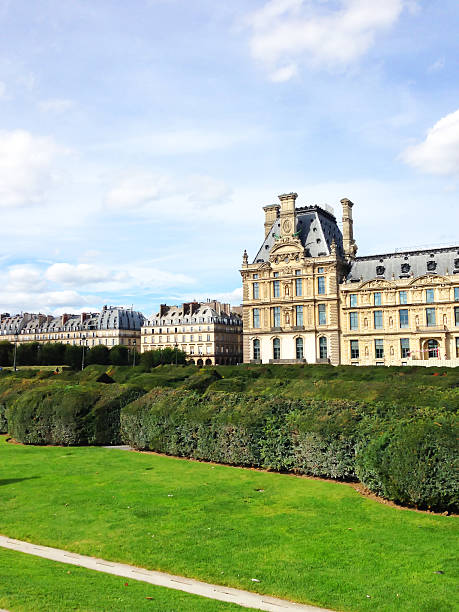 Paris, France - May 2019: Statue of Nymph in Tuileries garden and Louvre palace