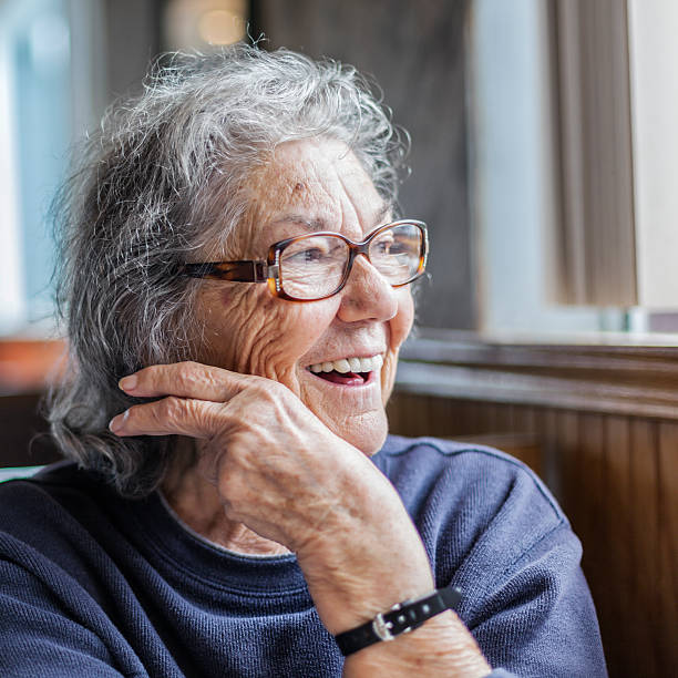 istock Elderly Woman With Dementia Looking Out Restaurant Window 526129258