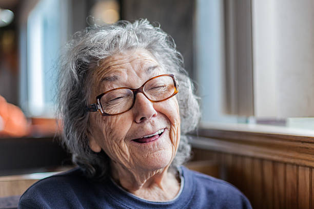 istock Playful Elderly Senior Woman Making Funny Face In Restaurant 526129320