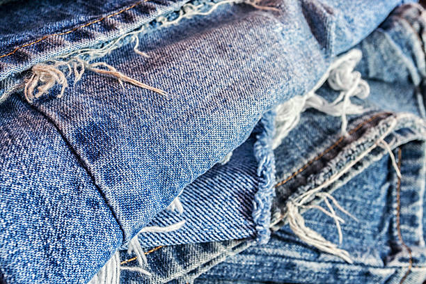istock Recycled Abstract Heap Of Old Worn Out Blue Jeans 526129376