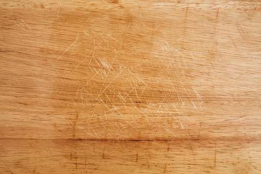 Old scratched wooden cutting board texture