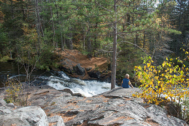 istock Little boy on a background of autumn forest and river 526131226