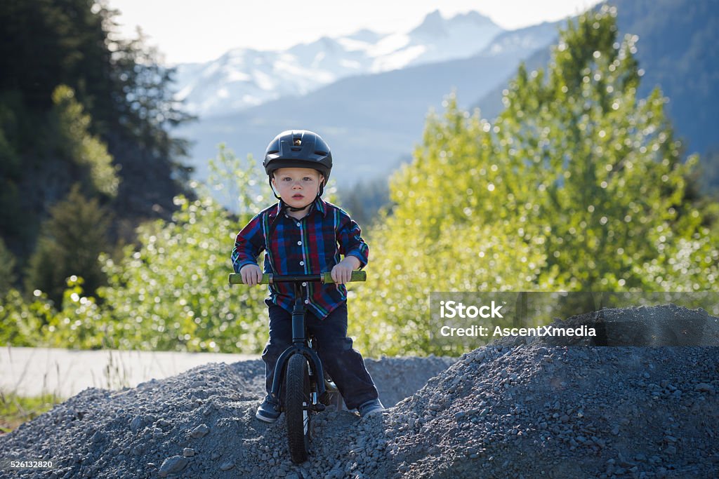 Kid on a run bike Portrait of a boy on a run bike wearing a helmet 12-17 Months Stock Photo
