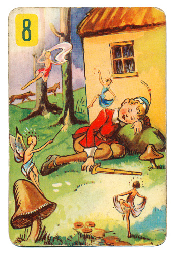 This is a Peter Pan playing card from British manufacturer Pepys with an illustration dating from 1939. Originally issued with green backs, this card is from a 1950s re-issue with red backs. The illustration shows Peter Pan asleep and surrounded by flying fairies.
