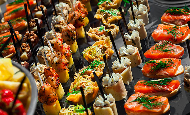 istock meat, fish, vegetable canapes wedding table outdoor 526134166