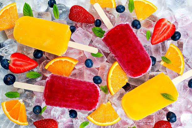 istock refreshing fruit popsicle lollies on ice background with berries,  peppermint 526135228