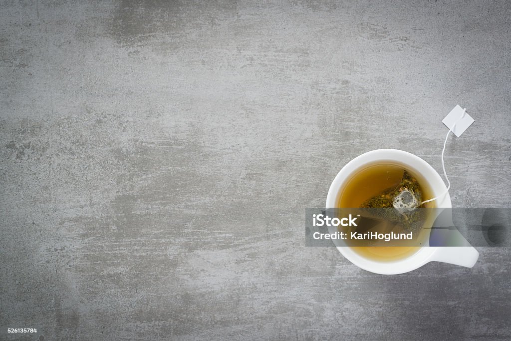 Cup of tea with teabag Cup of tea with teabag, on concrete stone background Tea - Hot Drink Stock Photo