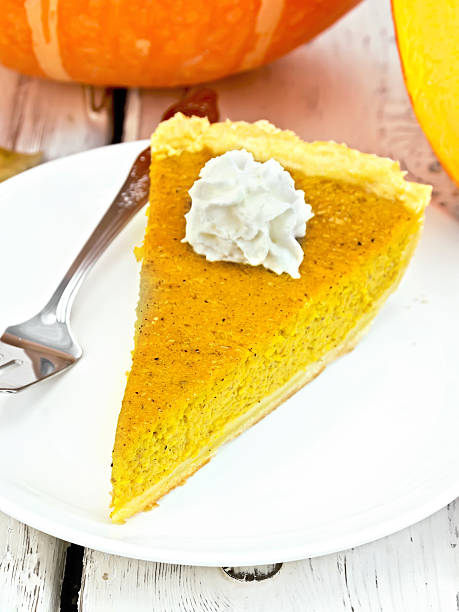 istock Pie pumpkin with whipped cream in plate on board 526136050