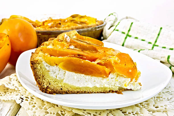 istock Pie with curd and persimmons in plate on napkin 526136182
