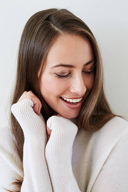 istock Beautiful brunette smiling on white sweater 526136722