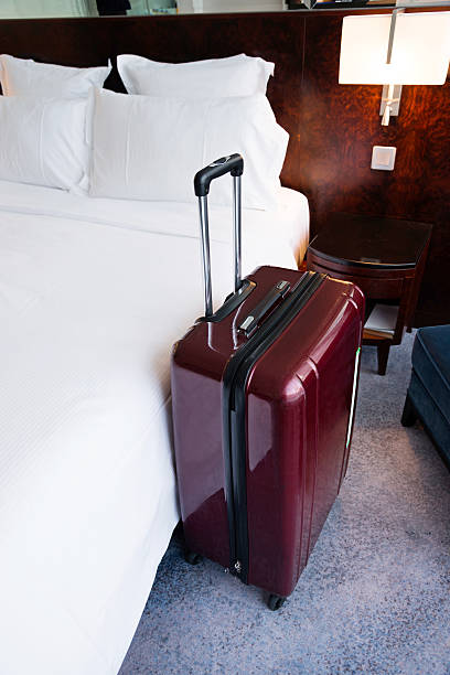 istock Suitcase in hotel room 526136750