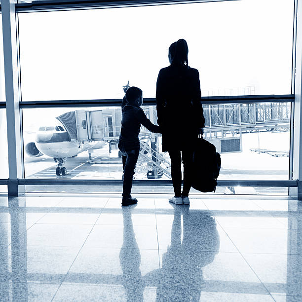 istock Young mother and son at airport 526137826