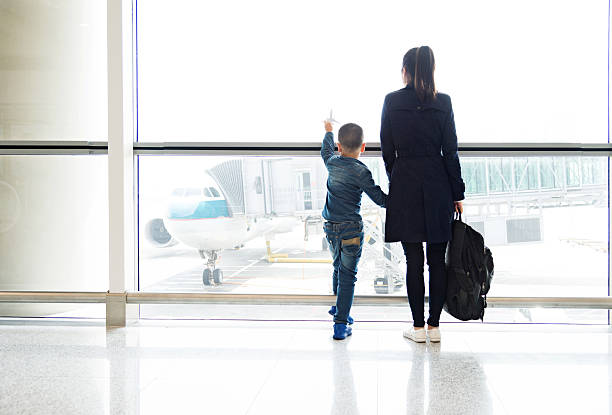 istock Young mother and son at airport 526137950