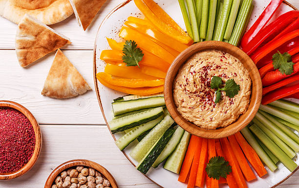 istock Homemade hummus with assorted fresh vegetables and pita bread. 526137988