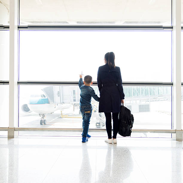 istock Young mother and son at airport 526138740