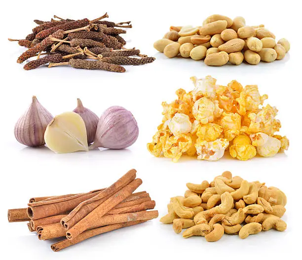 cashewnuts, peanuts, garlic, PopCorn, cinnamon on white background