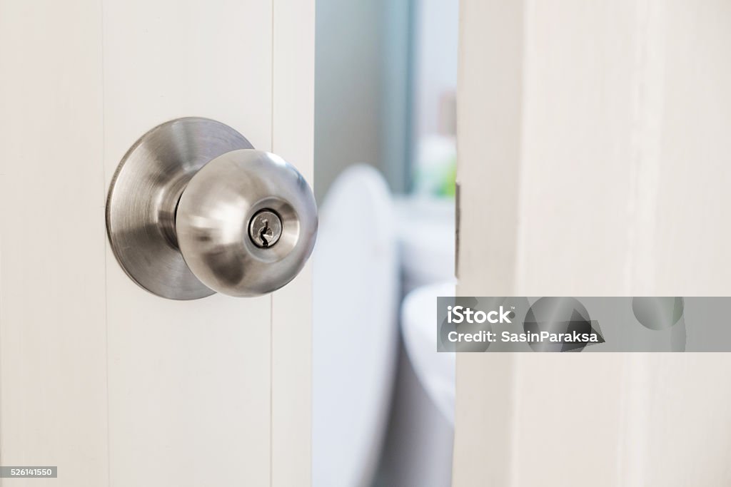 Close-up door stainless door knob, with door open slightly Doorknob Stock Photo